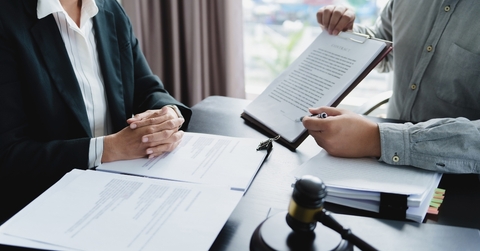lawyer signing legal document