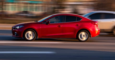 red mazda 3 moving