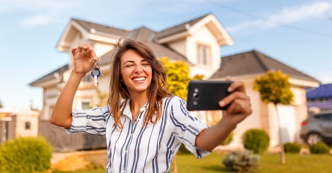 Woman taking a selfie with her new house keys