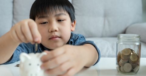 children putting coin for saving