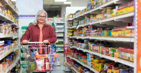 senior woman purchasing at grocery shop