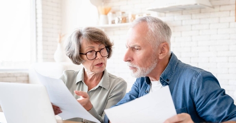 Concerned senior couple doing paperwork
