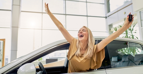 female got keys by her new automobile