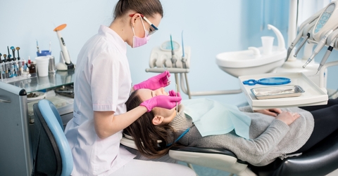 female dentist with dental tools