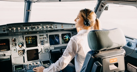 woman pilot sitting in airplane cockpit