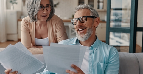couple in casual clothing taking care of their taxes