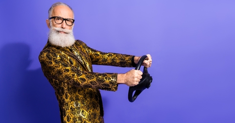 elderly man in flamboyant reptile print suit