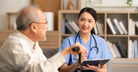 elder man patient talking to female doctor