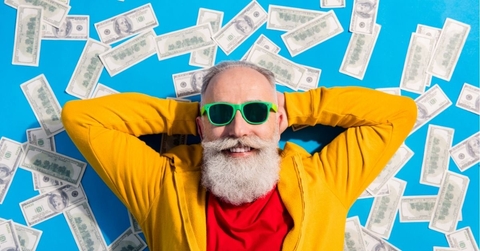 High angle view photo of positive smiling grandfather lying floor with money millionaire isolated on blue color background