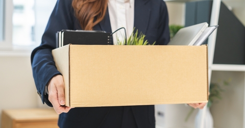 business woman holding her belongings