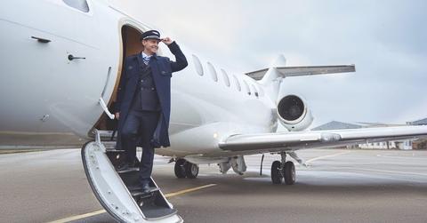 pilot standing on stairs of aircraft