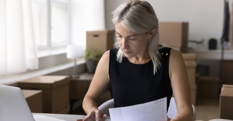 woman sit at office desk work with business papers