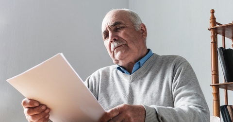 senior man reading a paper document