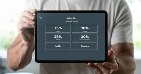 Man holding a tablet with tipping screen