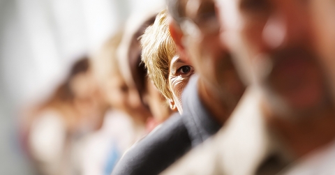 A woman out of focus with a group of people