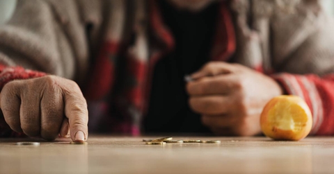 Poor senior man is counting change