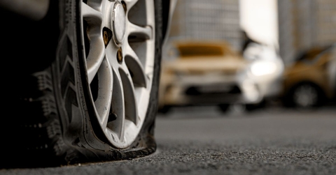 Close-up of a flat tire on a car