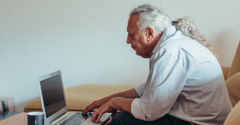 Older man working on laptop