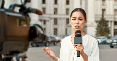 TV reporter presenting the news outdoors