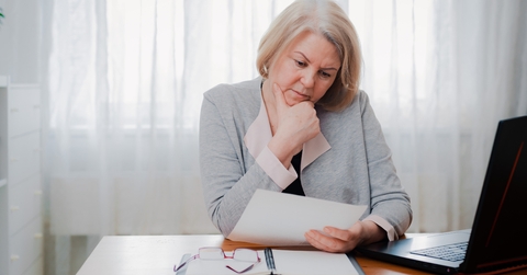 senior woman reading paper documents
