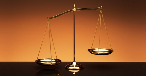 balance scale on orange background