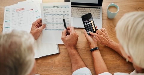 senior couple calculating their expenses