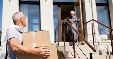 senior couple unloading cardboard boxes