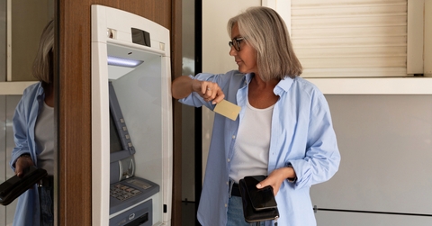 woman wants to withdraw money from an ATM