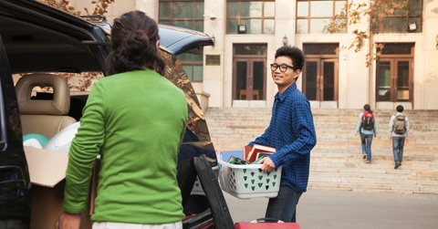 young man moving into dormitory