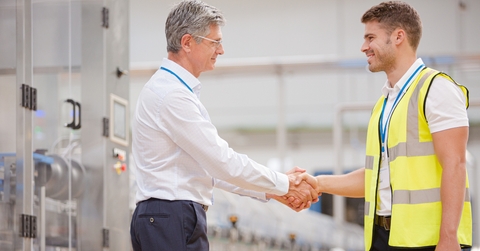 supervisor and worker shaking hands