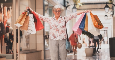 woman holding shopping bags looking happy