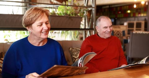 Senior couple with menu books in restaurant