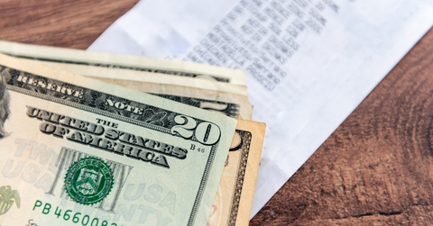 A stack of US Dollar bills on a table