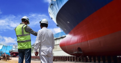 Engineers discuss ship repair plans on the dock