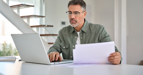 man calculating expenses