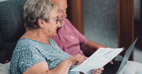 senior couple at home paying bills