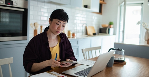 stressed woman reviewing bills and finances