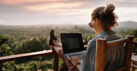 businesswoman working on laptop in cafe on the rock