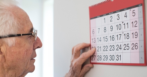 Older man looking at calendar