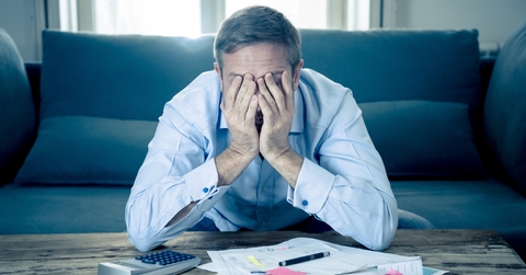 Upset man in stress paying bills