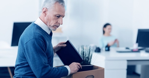 boomer aged man cleaning out desk
