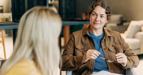 Mental health counselor speaking to patient