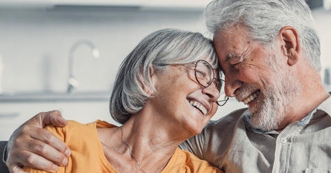 Senior couple smiling and hugging each other