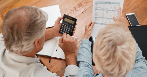 senior couple with calculator planning financial investments