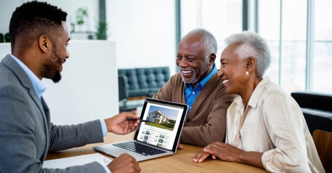 Happy couple talking to real estate agent