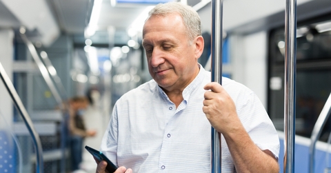 Man in the subway looking at his phone