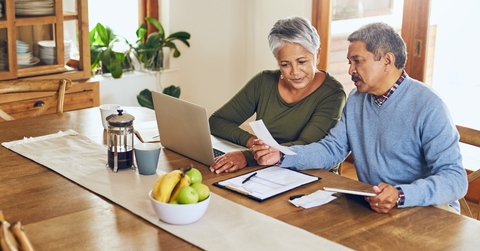 senior couple with bills