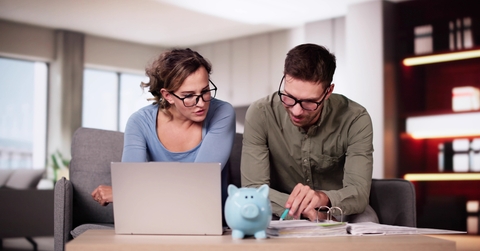 couple at home planning for saving money
