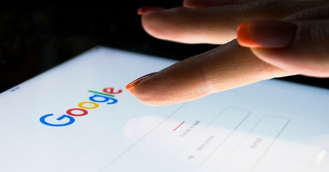 A woman&#x27;s hand is touching screen on tablet