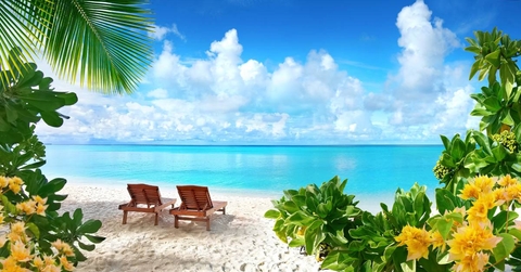 Beautiful tropical beach with white sand and two sun loungers